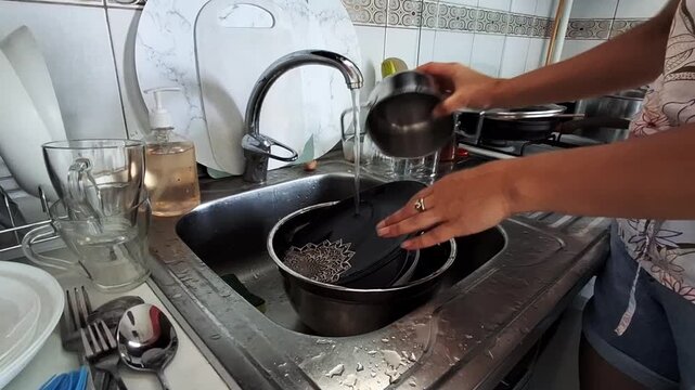 Doing the dishes in a small kitchen during the afternoon