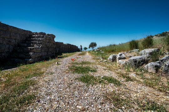 Ancient Fortification Wall and Visitor at Plevrona, Greece