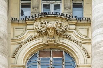 Carved female mask and floral relief above a balcony on the Stock Exchange Palace facade in Budapest, Hungary © GuillaumeAngleraud