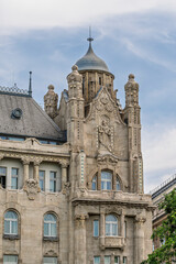 Fototapeta premium Corner turret and decorative stonework on the Art Nouveau facade of Gresham Palace in Budapest, Hungary