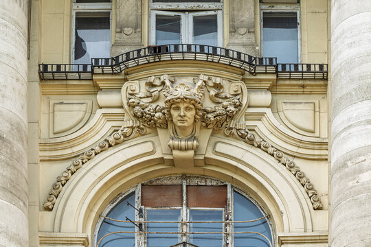Carved female mask and floral relief above a balcony on the Stock Exchange Palace facade in Budapest, Hungary