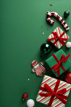 Christmas gifts with gingerbread cookie, ornaments and candy cane on vertical green background