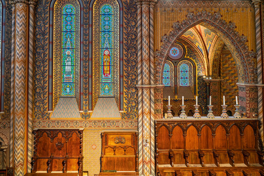 Carved wooden choir stalls and painted candlesticks in the sanctuary of Matthias Church in Budapest, Hungary