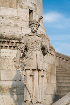 Stone statue of a medieval Hungarian warrior guard beside a turret of Fisherman's Bastion in Budapest, Hungary