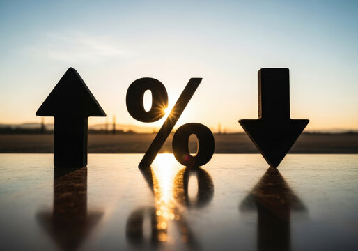 A silhouette of a percentage symbol, an upward arrow, and a downward arrow are dramatically set against a vibrant sunset sky.