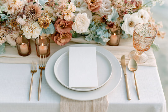Elegant wedding menu card displayed on a formal place setting with refined tableware