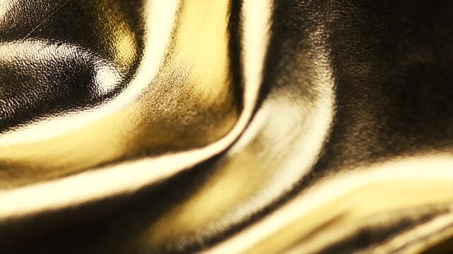 Golden leather texture background, glossy gold leather skin backdrop rotating, fashion. Slow motion. 