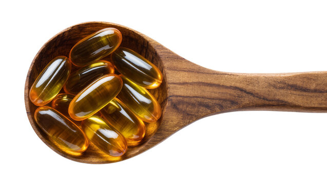 Isolated traditional wooden spoon filled with shiny golden fish oil omega 3 capsules.