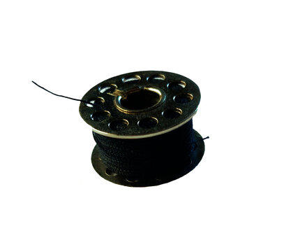 Black metal sewing thread bobbin spool isolated on white background