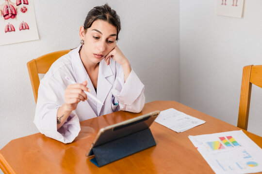Doctor telemedicine consulting with patient using digital tablet