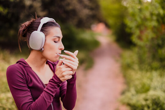 Young woman lighting a joint enjoying outdoor cannabis or cigarette