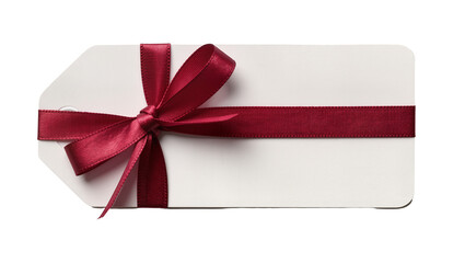 Isolated blank white gift tag with a festive red ribbon and bow, perfect for holiday greetings. © Saoirse