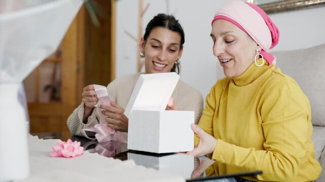 Daughter giving a surprise gift to cancer survivor mother