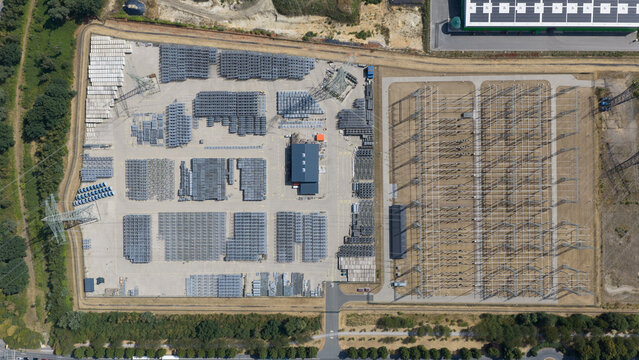 Aerial view of the Amprion Gmbh electrical substation featuring organized rows of industrial equipment, metal structures, and transformers in Herten, Nordrhein-Westfalen, Germany.
