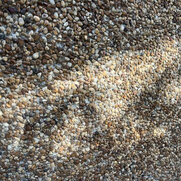 Natural stone pebble texture background, close up gravel surface