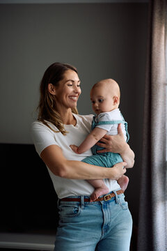Happy mother and her baby son at home.