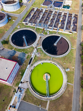 Water treatment facilities operate in a large area with multiple tanks for processing wastewater during daytime hours