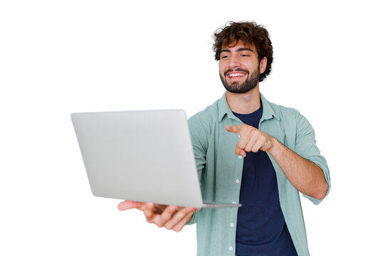 Young man holding an open laptop, pointing finger forward while smiling and communicating online, transparent background