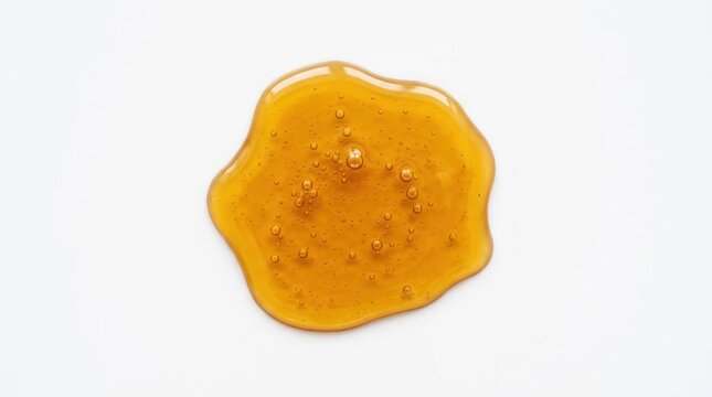 Viscous Amber Liquid Droplet Isolated on White Background.