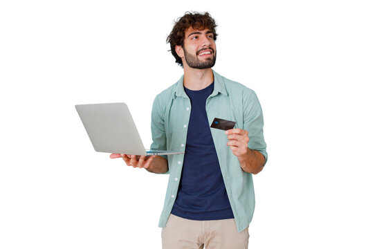 Smiling man holding laptop and credit card, thinking about secure online payment and e-commerce shopping