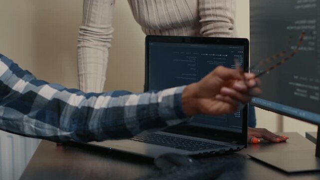 Programmer hands write code at an office workstation, connecting keyboard input, development tools and focused software engineering, during a developer productivity task.