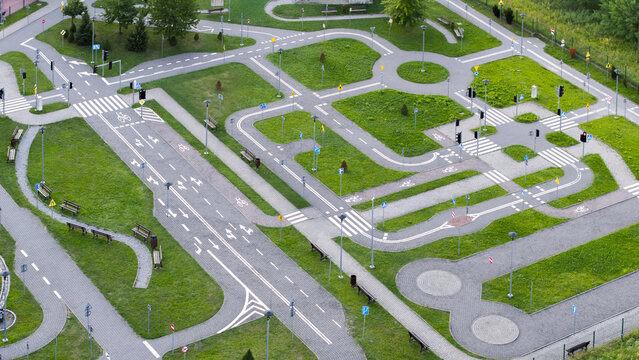 Aerial view of a miniature traffic training playground with paved roads, road markings, traffic signs, and pedestrian crossings in Wieliczka, Lesser Poland Voivode, Poland.