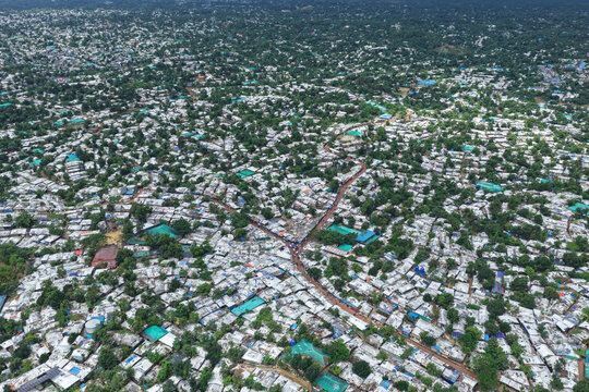 Aerial view of Camp 7 Kutupalang Expansion Sites showing dense rows of shelters with white roofs and green trees in Cox's Bazar District, Chittagong Division, Bangladesh.