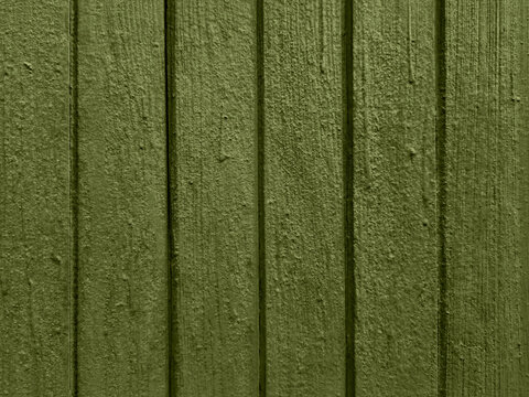 Old painted wooden door texture in olive green with vertical grooves weathered rustic surface detailed background natural grain vintage wall pattern seamless backdrop