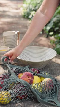 Close-up of Hand Picking Apples and Peaches from Basket