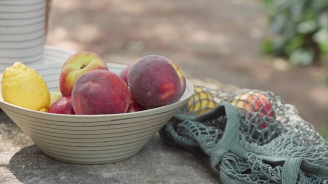Fresh Peaches in a Bowl on a Garden Table