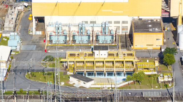 Aerial view of the Nuclear Power Plant Angra 2 featuring industrial buildings, electrical transformers, and cooling water discharge systems in Angra dos Reis, Rio de Janeiro, Brazil.