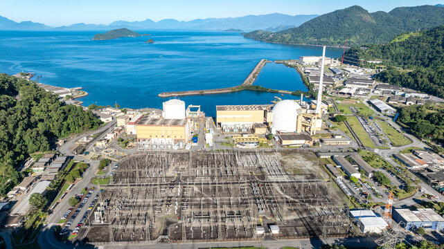 Aerial view of the Nuclear Power Plant Angra 2 with its white containment domes, industrial buildings, and electrical substation along the coast in Angra dos Reis, Rio de Janeiro, Brazil.