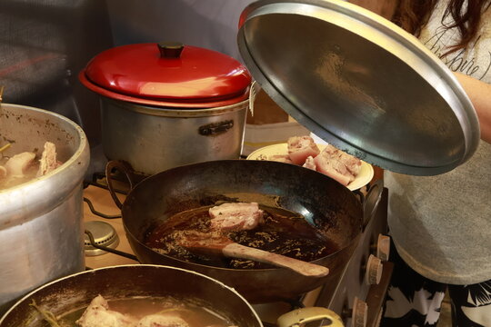 Pork meat cooking in hot lard for traditional Peruvian chicharr&oacute;n