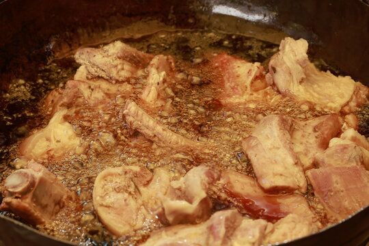 Pork meat cooking in hot lard for traditional Peruvian chicharr&oacute;n
