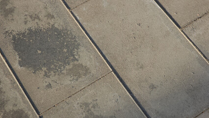 Fototapeta premium Detailed concrete pavement surface with square slabs, seams and natural texture suitable for architectural and design backgrounds