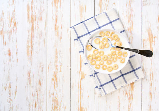 Healthy breakfast, bowl of corn loops with milk . Top view.