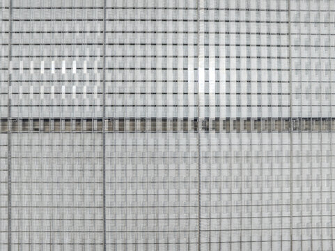 Aerial view of the modern geometric facade and roof structure of a building in Aschheim, Bavaria, Germany.