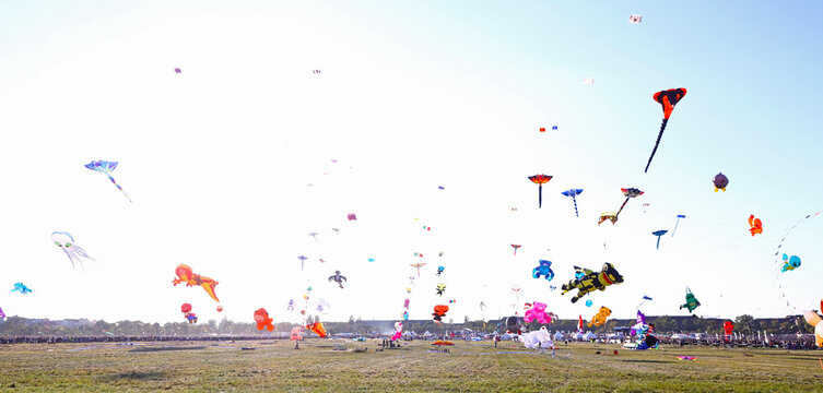 Berlin, Germany - September 27, 2025: Colorful giant kites soar above Tempelhofer Feld during Berlin's annual Festival der Riesendrachen, drawing families and kite lovers for a day of outdoor fun