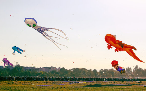 Berlin, Germany - September 27, 2025: Giant kites shaped as an octopus, frogs and Super Mario decorate the sky during the annual Festival der Riesendrachen at Tempelhofer Feld