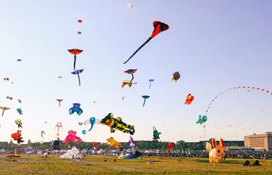 Berlin, Germany - September 27, 2025: Colorful giant kites soar above Tempelhofer Feld during Berlin's annual Festival der Riesendrachen, drawing families and kite lovers for a day of outdoor fun