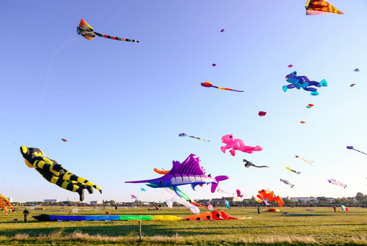 Berlin, Germany - September 27, 2025: Giant kites fill the sky above Tempelhofer Feld during the annual Festival der Riesendrachen, one of Berlin's most popular outdoor autumn events