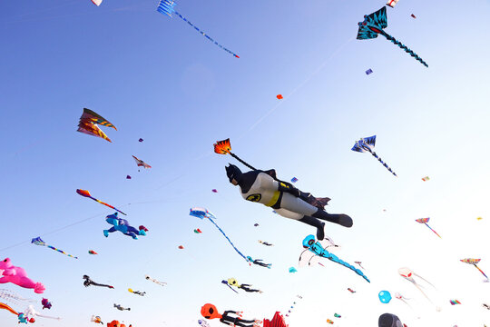 Berlin, Germany - September 27, 2025: Giant kites fill the sky above Tempelhofer Feld during the annual Festival der Riesendrachen, one of Berlin's most popular outdoor autumn events