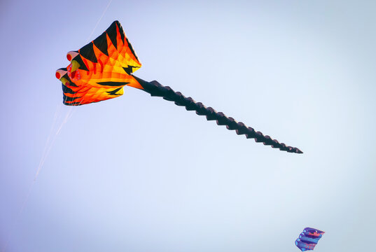Berlin, Germany - September 27, 2025: A giant dragon-shaped kite flies above Tempelhofer Feld during the annual Festival der Riesendrachen, one of Berlin's most popular family outdoor events