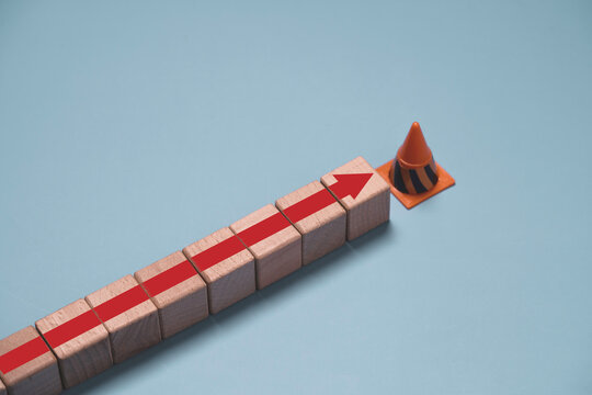 Business stop concept with a red arrow halted by a traffic cone, representing business interruption, operational halt, workflow disruption, risk management, decision making, and process control.