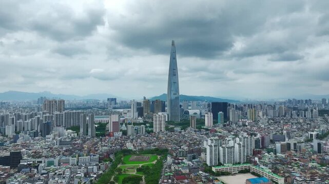 Aerial Drone View of Jamsil Station Cityscape, Lotte World Tower, and Han River Landscape in Seoul, South Korea