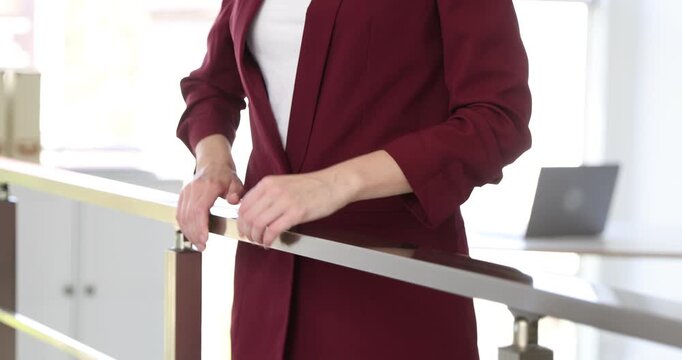 Woman measuring her pulse in office, closeup