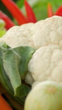 Fresh organic cauliflower head in a kitchen vegetable basket