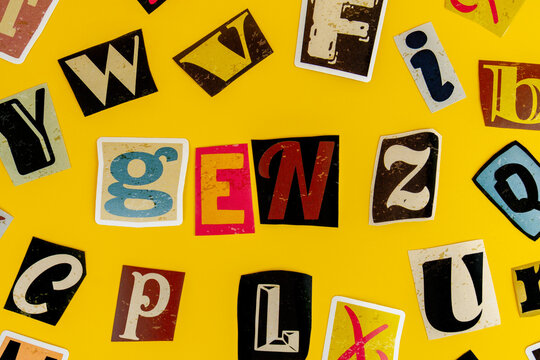 Cutout letters spelling Gen Z on a yellow background. Generation Z, modern youth culture, demographic marketing concept.