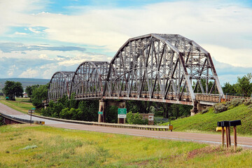 Fototapeta premium The Lewis and Clark Bridge on the Missouri River at Wolf Point Montana. It is a 3-span Pennsylvania through-truss structure and is 1,074 feet long