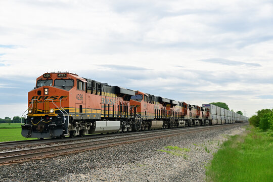 Five Burlington Northern Santa Fe locomotives provide front-end power for an eastbound intermodal freight train passing through a rural section of north central Illinois.